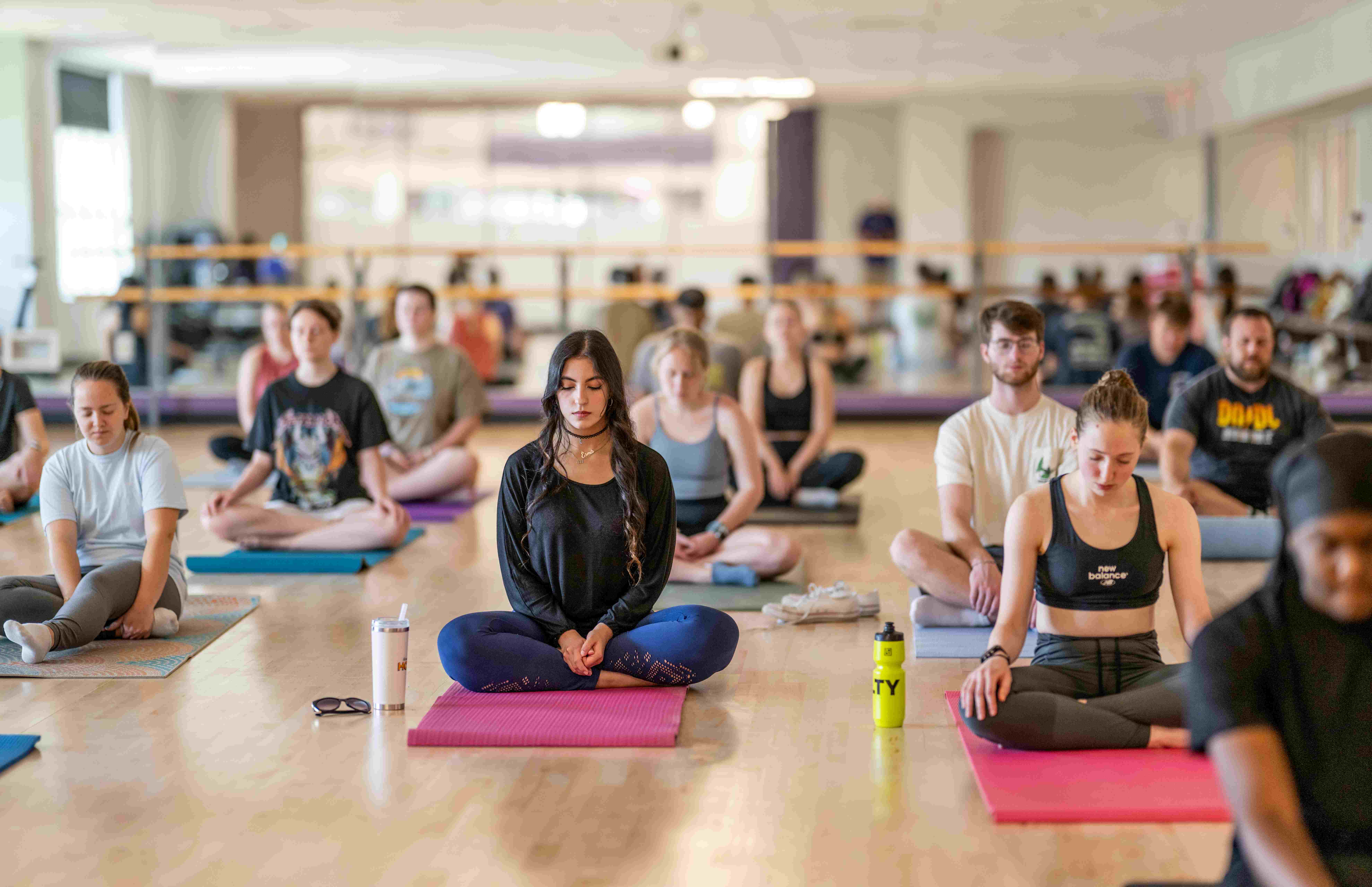 Participants in an easy seated position during a yoga class