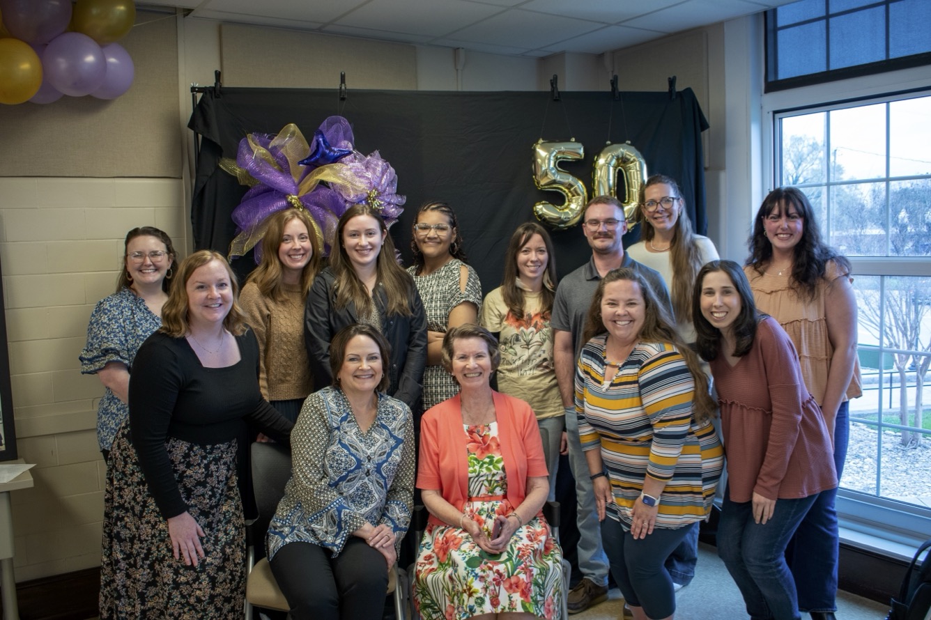 Faculty, students, and alumni gather for a group photo celebrating dietetics program's 50th anniversary.