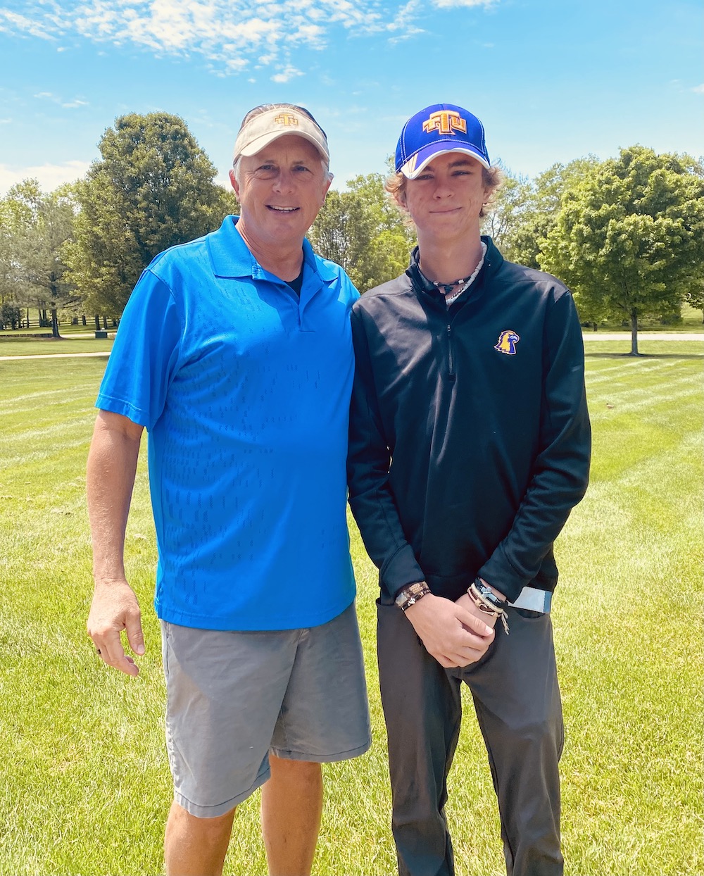 Darren Bassel on a golf course with son, Alexander