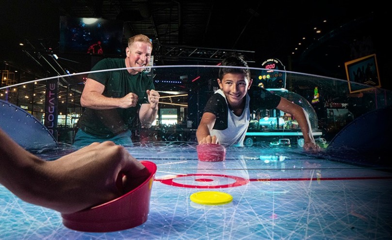 Photo of people playing air hockey