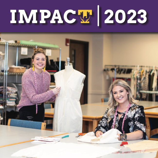Cover of Impact Magazine featuring two fashion design students