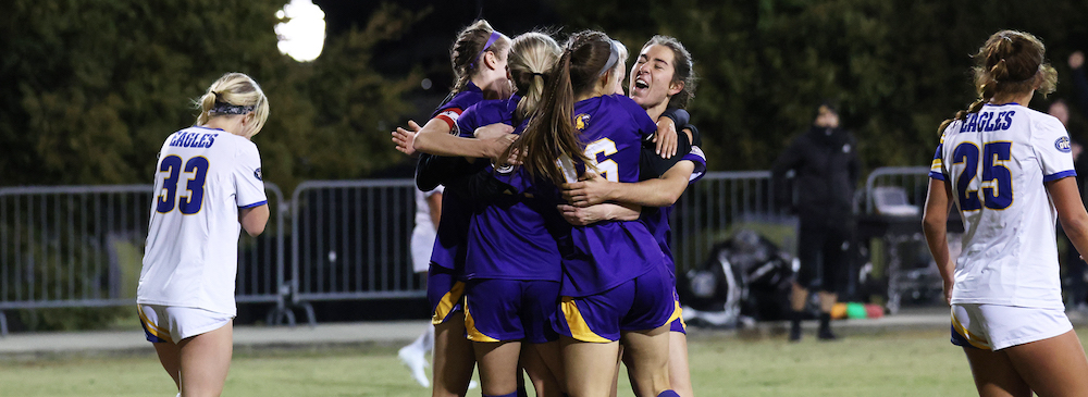 Members of the Tennessee Tech soccer team embrace on the field.