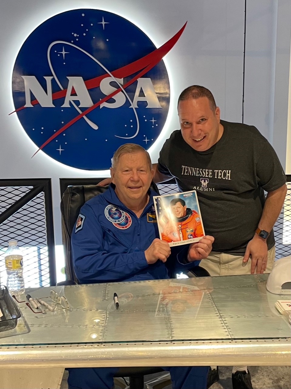 Dr. Roger Crouch poses with a signed photo of himself and Shawn Ratner