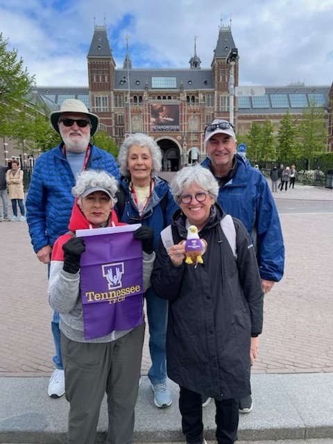 5 people smiling holding Tennessee Tech flag